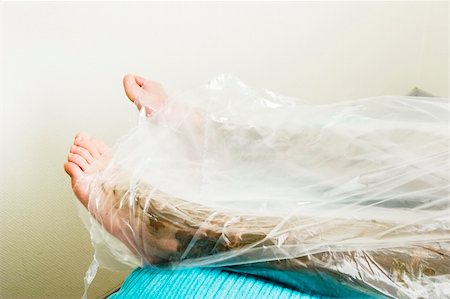 plastic wrap person - A detail image of the feet wrapped in during a sea mud full body wrap at a luxury spa. Stock Photo - Budget Royalty-Free & Subscription, Code: 400-05015947