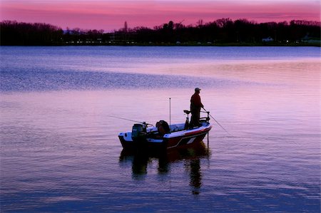 A man fishing in the early morning or early evening from his boat. Stock Photo - Budget Royalty-Free & Subscription, Code: 400-05016654