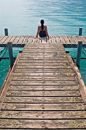 Woman contemplating in wooden dock Stock Photo - Budget Royalty-Free & Subscription, Code: 400-05016954