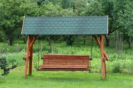swing bench - Swinging bench in the garden Stock Photo - Budget Royalty-Free & Subscription, Code: 400-05018425