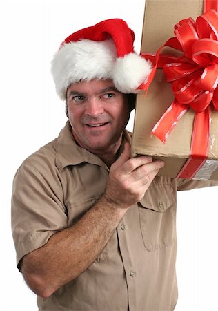 simsearch:700-01716484,k - a delivery man in a Santa hat listening to a gift he's supposed to deliver Foto de stock - Royalty-Free Super Valor e Assinatura, Número: 400-05019527