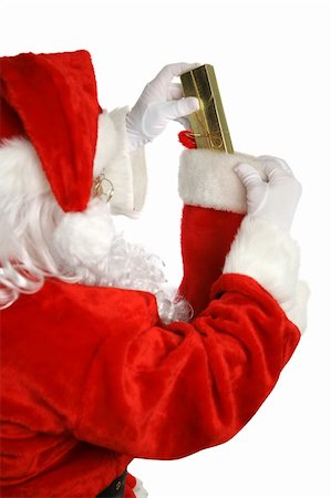 simsearch:400-04636742,k - Santa Claus stuffing a gift into a Christmas stocking.  Focus on gift.  Isolated on white. Foto de stock - Royalty-Free Super Valor e Assinatura, Número: 400-05019520