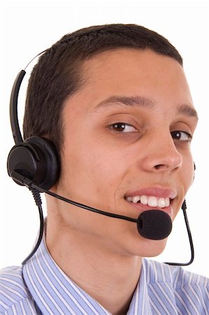 simsearch:400-04129170,k - Young man smiling with telephone headset Fotografie stock - Microstock e Abbonamento, Codice: 400-05010391