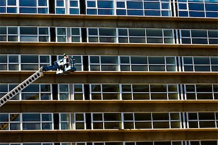 Maintenance worker in a crane inspecting a new residential building Stock Photo - Budget Royalty-Free & Subscription, Code: 400-05010988