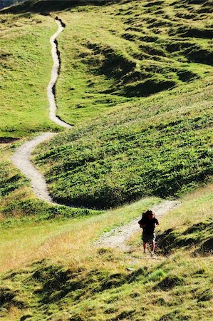 people scenic view sky hiking summer - Trekker walking along a mountain path, Mont Blanc valley, west Alps, Italy. Stock Photo - Budget Royalty-Free & Subscription, Code: 400-05011055