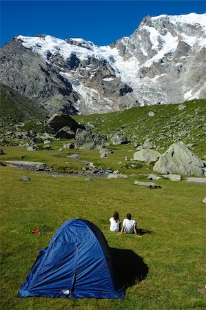 Young couple of trekkers sitting outside their tent in a green meadow in front of the east face of Monte Rosa massif, West Alps, Italy. Stock Photo - Budget Royalty-Free & Subscription, Code: 400-05011050