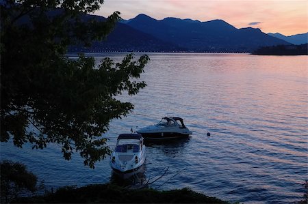 Small yachts anchored in quite lake water before the dawn; Maggiore Lake, Italy. Stock Photo - Budget Royalty-Free & Subscription, Code: 400-05011138