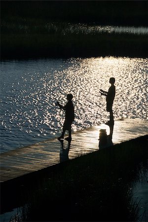 simsearch:400-04468744,k - Birds eye view of two teenage boys fishing from dock at Bald Head Island, North Carolina. Stock Photo - Budget Royalty-Free & Subscription, Code: 400-05012362