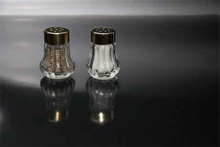 salt and pepper - Salt and pepper shakers on black background Stock Photo - Budget Royalty-Free & Subscription, Code: 400-05012678