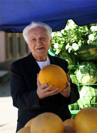 food market old people - Old man at the marketplace picking a melon Stock Photo - Budget Royalty-Free & Subscription, Code: 400-05012823