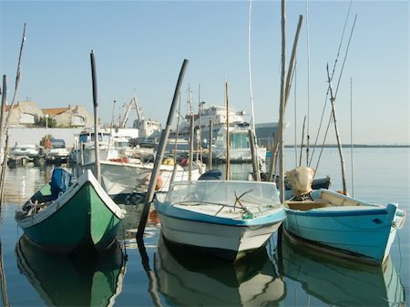 small boats with a big one in the back Stock Photo - Budget Royalty-Free & Subscription, Code: 400-05012915