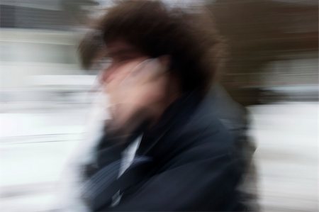 A motion blur abstract of a person walking in a hurry talking on a cell phone Stock Photo - Budget Royalty-Free & Subscription, Code: 400-05012950