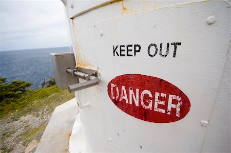 Keep out. Sign on the base of a lighthouse on the coast of Newfoundland. Stockbilder - Microstock & Abonnement, Bildnummer: 400-05013788