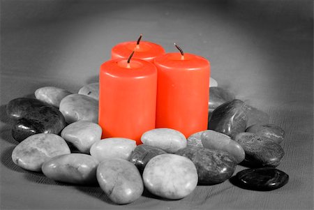 Three unlit red candles sitting in a pile of river rocks with only the candles in color Stock Photo - Budget Royalty-Free & Subscription, Code: 400-05025808