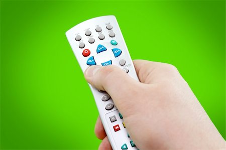 simsearch:400-05223721,k - Remote control in hand on green background Foto de stock - Royalty-Free Super Valor e Assinatura, Número: 400-05025899