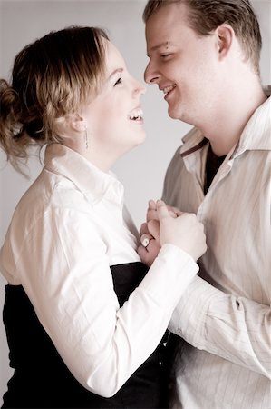simsearch:400-03969572,k - Studio portrait of a young amorous couple laughing Fotografie stock - Microstock e Abbonamento, Codice: 400-05026106