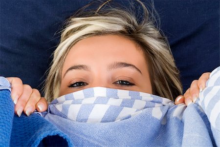 blond and cute girl playing with blue sheet on her bed and making face Stock Photo - Budget Royalty-Free & Subscription, Code: 400-05026501