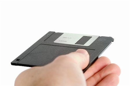 person holding up mask - A hand holding a 3 1/2" computer disk.  Isolated on white with clipping path. Stock Photo - Budget Royalty-Free & Subscription, Code: 400-05026803