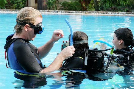 Scuba diving instructor demonstates a skill to a student in a swimming pool. Stock Photo - Budget Royalty-Free & Subscription, Code: 400-05027210