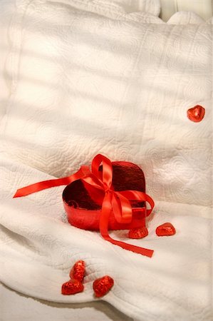 simsearch:400-05027600,k - Box of chocolates with red ribbon on a bed for Valentin's day Stock Photo - Budget Royalty-Free & Subscription, Code: 400-05027599