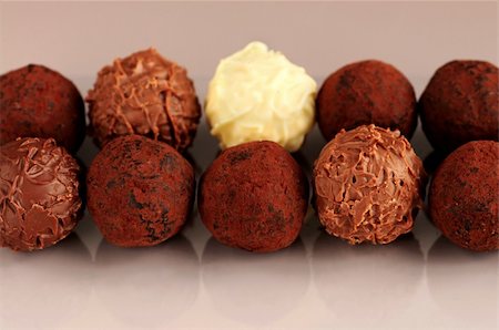 Several assorted chocolate truffles in rows on brown background Stock Photo - Budget Royalty-Free & Subscription, Code: 400-05028052