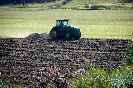 A farmer ploughs his field with a tractor. Stock Photo - Budget Royalty-Free & Subscription, Code: 400-05028570