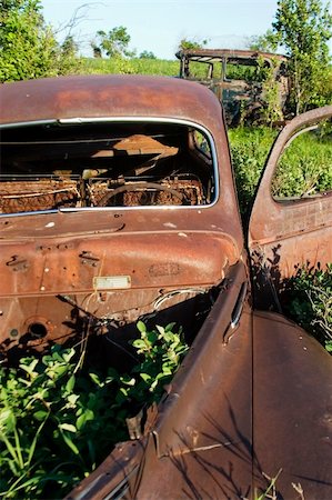 An old car sitting on the prairie forgotten and overgrown with bushes. Stock Photo - Budget Royalty-Free & Subscription, Code: 400-05028573