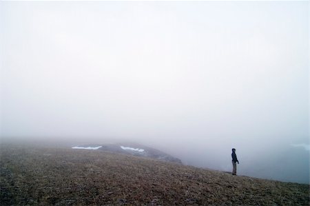 rainy season man walking - Standing on the edge of a hill wondering Stock Photo - Budget Royalty-Free & Subscription, Code: 400-05028595