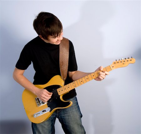 guitarist teenage boy playing guitar Stock Photo - Budget Royalty-Free & Subscription, Code: 400-05028837