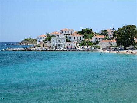 simsearch:400-05118735,k - A part of Spetses island town, Greece; traditional houses, a small beach, and a lighthouse can be seen Stock Photo - Budget Royalty-Free & Subscription, Code: 400-05028967