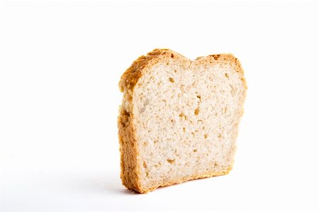 A single slice of homemade bread on a white background. Foto de stock - Super Valor sin royalties y Suscripción, Código: 400-05029023