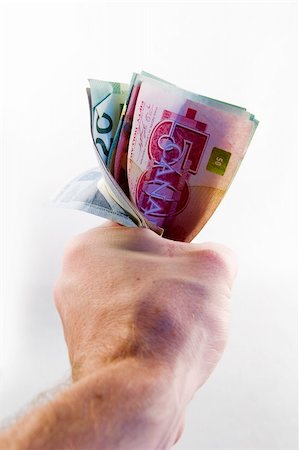 A male hand holding a tight wad of Canadian money. Stock Photo - Budget Royalty-Free & Subscription, Code: 400-05029757
