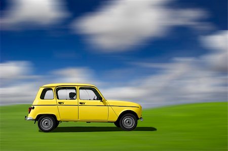 french road cars - Yellow classic car at high speed in a green meadow (motion effect) Stock Photo - Budget Royalty-Free & Subscription, Code: 400-05029849
