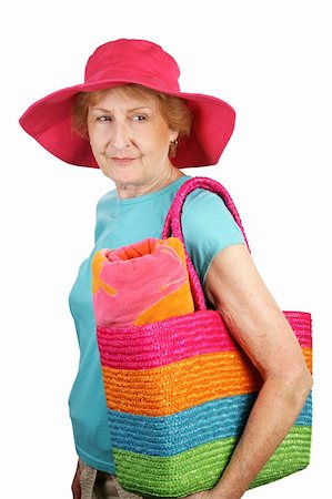 A senior dressed for the beach looking back over her shoulder.  Isolated on white. Stock Photo - Budget Royalty-Free & Subscription, Code: 400-05020366