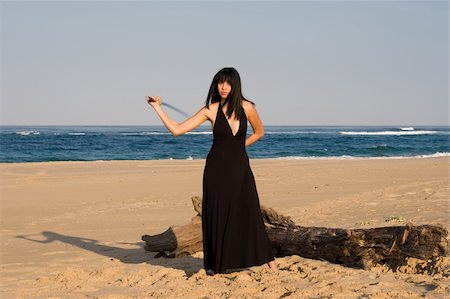 rapier - Asian model swinging a sword at the beach Photographie de stock - Aubaine LD & Abonnement, Code: 400-05020864