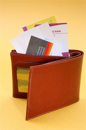 simsearch:400-06921414,k - Brown leather wallet isolated on yellow Photographie de stock - Aubaine LD & Abonnement, Code: 400-05020906