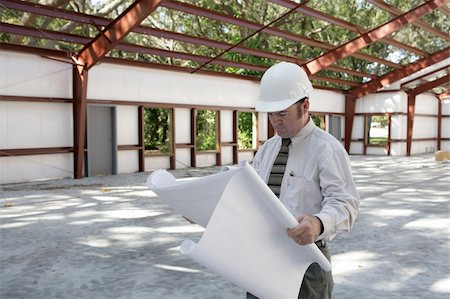 simsearch:400-04485408,k - An architect going over blueprints on the jobsite.  Steel frame construction. Stock Photo - Budget Royalty-Free & Subscription, Code: 400-05021167