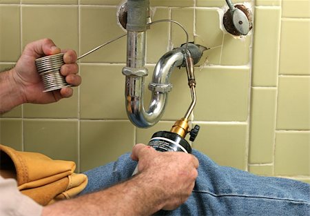 plumbing leak - A plumber using a welding torch to solder pipe in the bathroom. Stock Photo - Budget Royalty-Free & Subscription, Code: 400-05021217