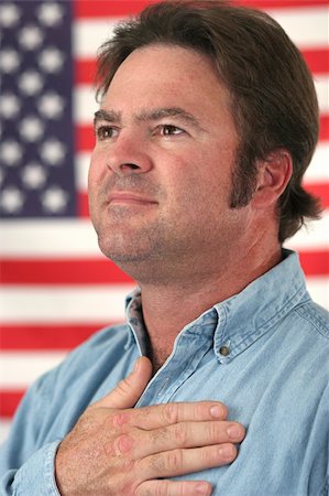 A handsome man pledging alliegance to the American flag. Stock Photo - Budget Royalty-Free & Subscription, Code: 400-05021832