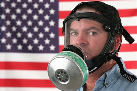 A concerned man wearing a gas mask and posing in front of an american flag. Stock Photo - Budget Royalty-Free & Subscription, Code: 400-05021855
