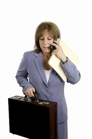 simsearch:400-03972372,k - A businesswoman trying to do too many things at once.  She is stressed & frustrated.  Isolated on white. Stock Photo - Budget Royalty-Free & Subscription, Code: 400-05021962