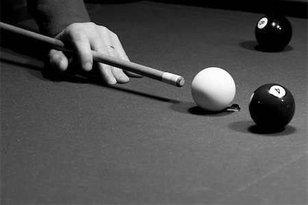simsearch:400-08160849,k - Man is aiming the billiard shot - cue is in his hand, and the balls are on the table. Picture was taken in low light, to preserve the real billiard light "three lamps" reflection on the ball. Foto de stock - Super Valor sin royalties y Suscripción, Código: 400-05022046