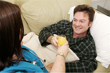 fat men in uniform - Man home sick taking a glass of orange juice from his home health nurse. Stock Photo - Budget Royalty-Free & Subscription, Code: 400-05022191