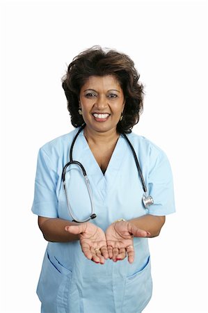 A doctor or nurse in scrubs holding out her hands palms up.  Isolated on white. Stock Photo - Budget Royalty-Free & Subscription, Code: 400-05022217
