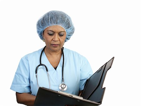 A nurse in scrubs and a surgical cap reviewing a patient's chart.  Isolated on white. Stock Photo - Budget Royalty-Free & Subscription, Code: 400-05022233