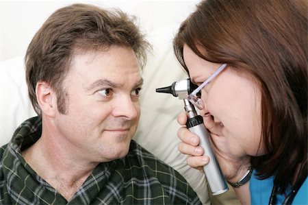 fat men in uniform - Nurse examining her patient's eyes with an ophtalmoscope. Stock Photo - Budget Royalty-Free & Subscription, Code: 400-05022338