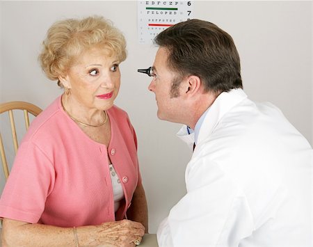 eye doctor test - Optician looking into a senior woman's eyes during a routine eye exam. Stock Photo - Budget Royalty-Free & Subscription, Code: 400-05022349