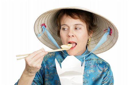 Tourist in Chinatown sampling a chinese dumpling from a takeout container.  Isolated on white. Stock Photo - Budget Royalty-Free & Subscription, Code: 400-05022358
