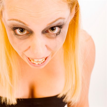 Studio portrait of a young blond woman looking crazy Stock Photo - Budget Royalty-Free & Subscription, Code: 400-05022696
