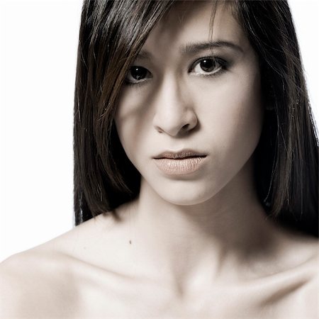 Studio portrait of a beautiful mixed race, vietnamese girl with an angry look Foto de stock - Super Valor sin royalties y Suscripción, Código: 400-05022861